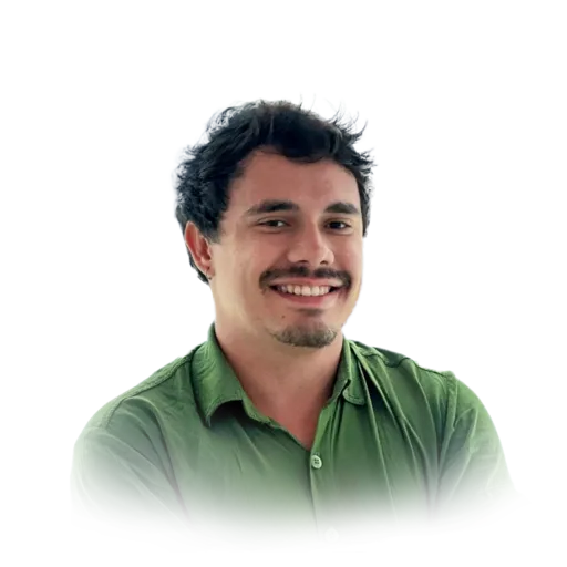 Abner wearing a green shirt against a light blue background. His hair is short and wavy. He's smiling.